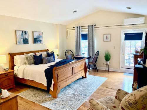 a bedroom with a bed and a living room at Suites On King in Niagara on the Lake