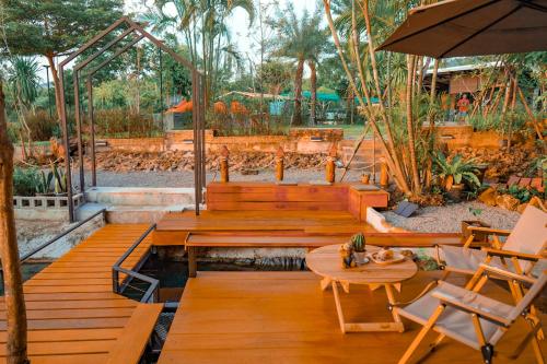 a patio with a table and chairs and an umbrella at Heaven Hill Camping in Ban Thung Na