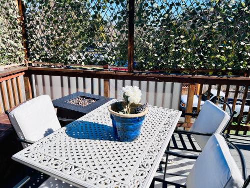 a white table with a potted plant on a patio at MountForest in Shoreline
