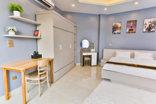 a bedroom with a bed and a table and a desk at Light House - by BAY LUXURY in Hanoi