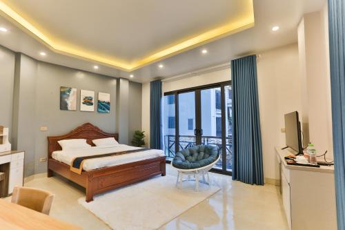 a bedroom with a bed and a television and a balcony at Light House - by BAY LUXURY in Hanoi