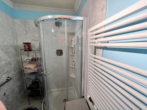 a shower with a glass door in a bathroom at MountForest in Shoreline