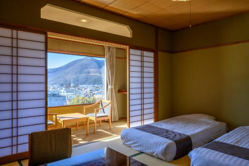 Postel nebo postele na pokoji v ubytování Isawa Tokiwa Hotel