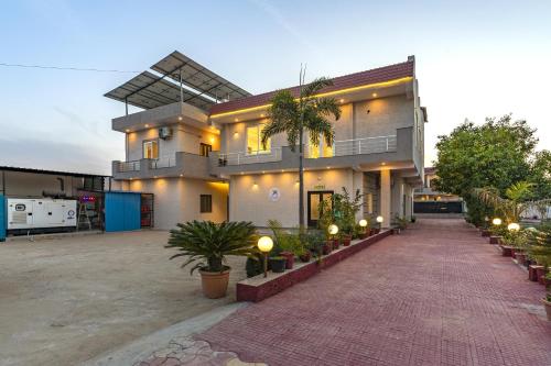 a house with a lot of plants in front of it at Zostel Homes Pushkar in Pushkar