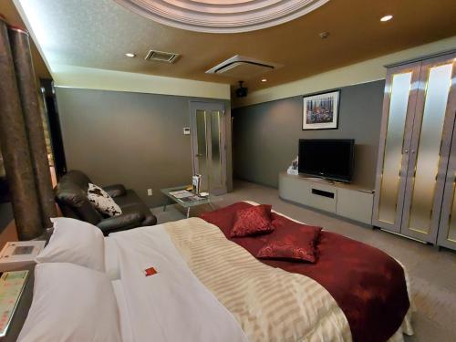 Una cama o camas en una habitación de ホテルセリーヌ(大人限定)