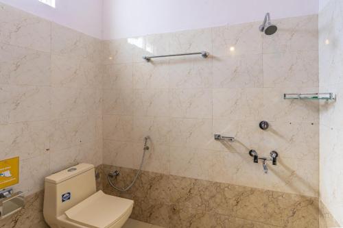 a bathroom with a toilet and a shower at Zostel Homes Pushkar in Pushkar