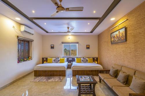 a living room with two beds and a couch at Zostel Homes Pushkar in Pushkar