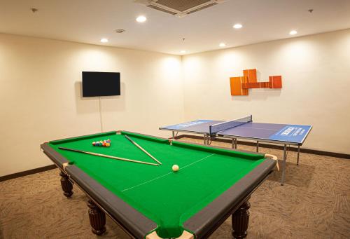 a pool table in a room with two tables at Somerset Greenways Chennai in Chennai