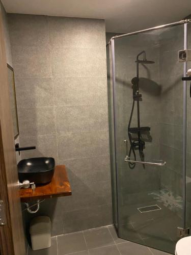 a shower with a glass door in a bathroom at Amara PhuQuoc Hotel in Phú Quốc