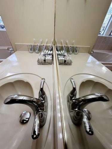 two sinks in a bathroom with chrome faucets at Super Cosy 8Bed & 6Bath in Vancouver heart near to airport and DownTown in Vancouver