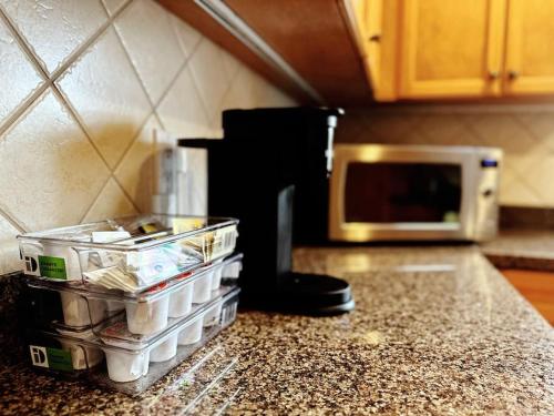 a kitchen counter with a tray of food and a microwave at Super Cosy 8Bed & 6Bath in Vancouver heart near to airport and DownTown in Vancouver