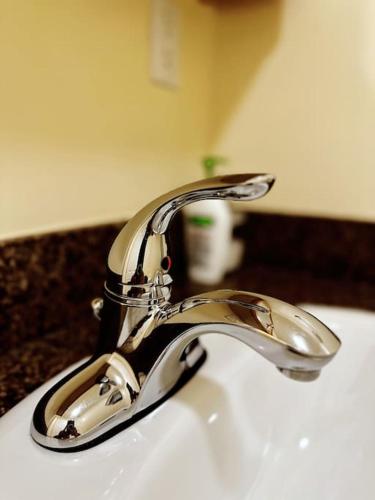 a bathroom sink with a chrome bathroom faucet at Super Cosy 8Bed & 6Bath in Vancouver heart near to airport and DownTown in Vancouver