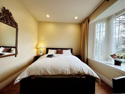 a bedroom with a large bed and a window at Super Cosy 8Bed & 6Bath in Vancouver heart near to airport and DownTown in Vancouver