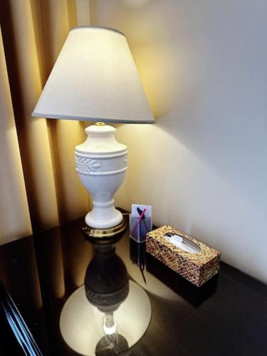 a white lamp sitting on a table next to a box at Super Cosy 8Bed & 6Bath in Vancouver heart near to airport and DownTown in Vancouver