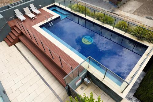 an overhead view of a swimming pool on a building at The Strand 303 in Forster