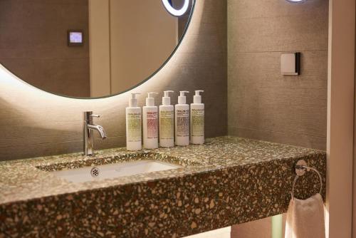 a bathroom counter with a sink and a mirror at L7 GANGNAM by LOTTE in Seoul