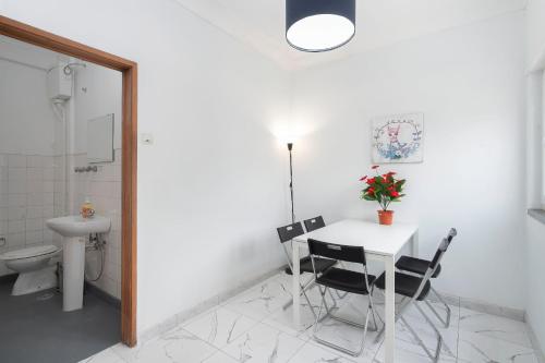 a bathroom with a table and chairs and a toilet at Happy Holiday Cascais - Home in Cascais