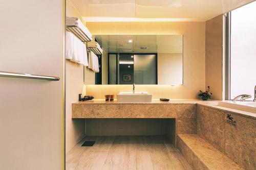 a bathroom with a sink and a mirror at Kwangsu Hotel Haeundae in Busan