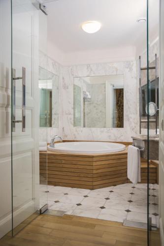 a large bathroom with a tub and a shower at Corinne Art & Boutique Hotel in Istanbul