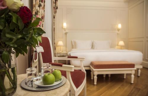 a hotel room with a bed and a table with a plate of fruit at Corinne Art & Boutique Hotel in Istanbul