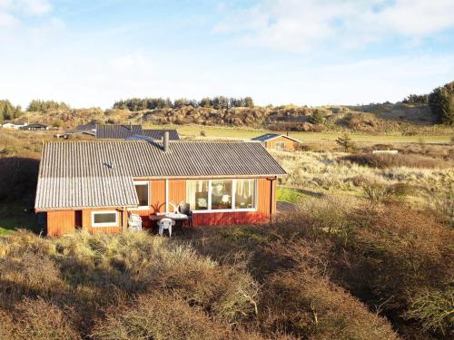 a small house in the middle of a field at 12 person holiday home in Hjørring-By Traum in Hjørring