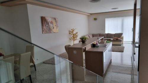 a living room with a table and a couch at Sarkcsillag teljes családiház- Star Complete Family House in Szeged