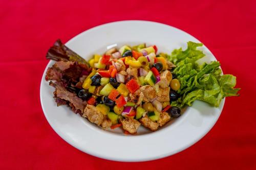 a plate of food with a salad on a red table at After 40 Hotel in Nairobi