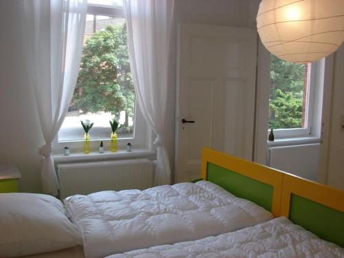 a bedroom with a large bed and a window at Idyllische Ferienwohnung auf altem Bauernhof mit Wallbox in Emmerthal