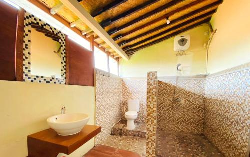a bathroom with a sink and a toilet in it at Urban Jungle House Bali in Canggu