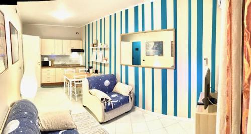 a living room with a blue and white striped wall at Sanremo Residence sul mare in Sanremo