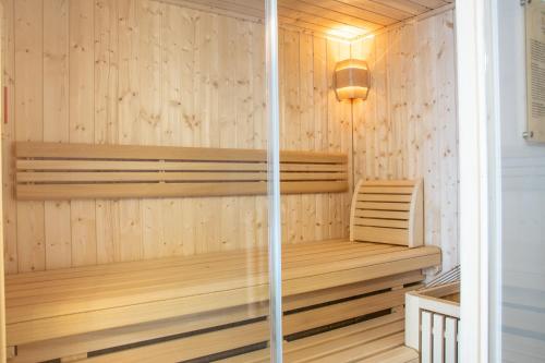 a sauna with wooden paneling and a light fixture at Löckerwirt in Sankt Margarethen im Lungau