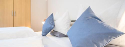 two blue pillows on a bed in a room at Weisses Rössl in Pfreimd