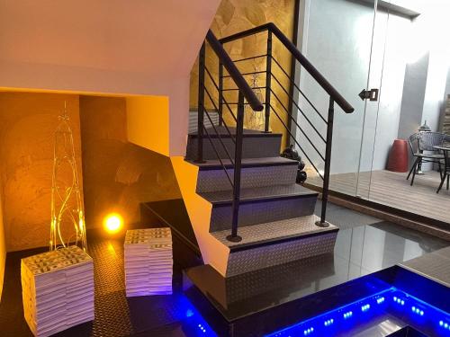 a staircase in a house with blue lights at Yosemite Motel - Chunghua Branch in Taichung