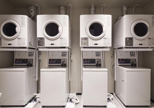 a bunch of microwaves and washers in a room at HOTEL AlaCOOJU OKINAWA in Urasoe
