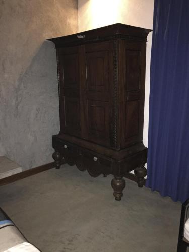 a wooden cabinet sitting in the corner of a room at Nagenahira Beach Villa in Nilaveli