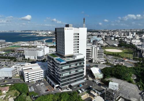 an overhead view of a city with a tall building at HOTEL AlaCOOJU OKINAWA in Urasoe