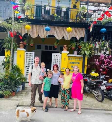 a family posing for a picture in front of a building at An Bang Sea Adventure Homestay Hoi An in Hoi An