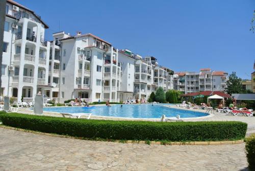a swimming pool in front of some apartment buildings at Bravo 5 Holiday Home in Sunny Beach