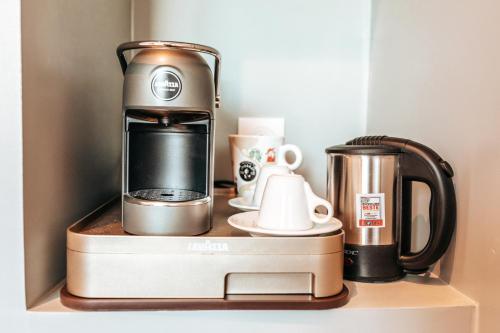 a coffee maker sitting on top of a shelf at Le Coq Hardi in Blangy-le-Château