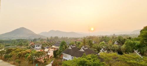 a village with houses and mountains in the background at Phu Pha Phung Resort in Suan Phung