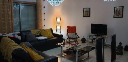 a living room with a couch and a tv at Splendor Residence Apartment in Portimão