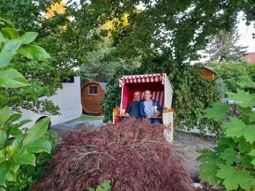 a picture of two men sitting in a red shed at Hotel Columbus und Glamping in Bremerhaven