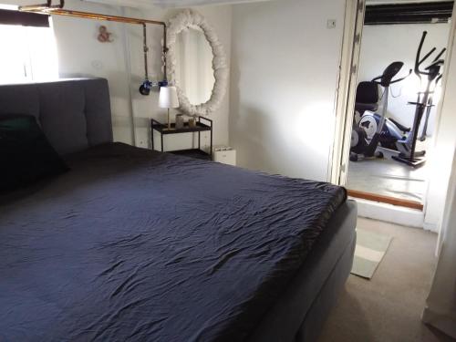 um quarto com uma cama, um espelho e uma passadeira em Københavnsvej em Roskilde