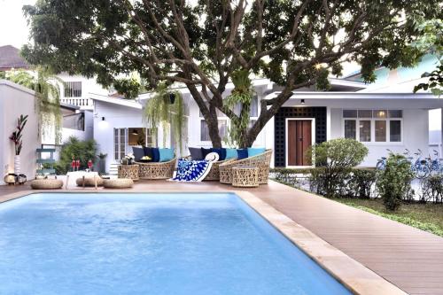 a swimming pool in front of a house at Private Pool Villa 89 Nimman Chiang Mai in Chiang Mai
