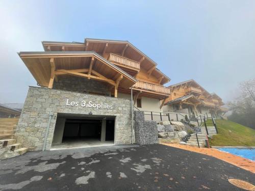 a house with a stone garage in the driveway at Alpine Creek - Luxury Ski-in Avoriaz Morzine in Morzine