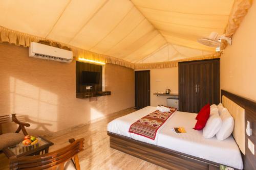 a bedroom with a bed and a tv in a room at Zostel Homes Pushkar in Pushkar