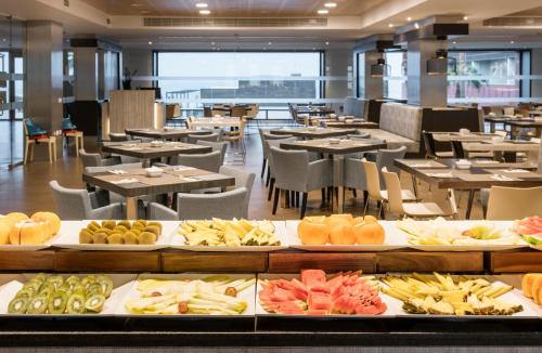 a buffet line with different types of food on display at Ilunion Calas de Conil in Conil de la Frontera