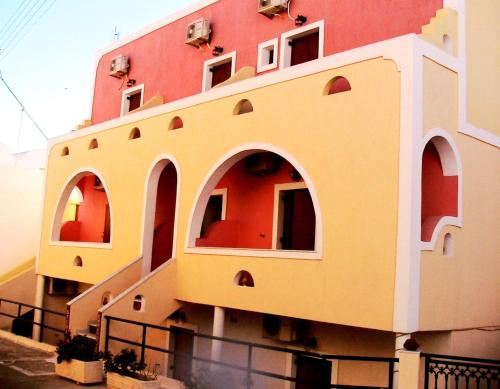 a building with arches on the side of it at Emmanouela Studios & Villas in Karterados