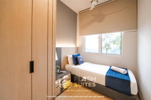 a small bedroom with a bed and a window at Windmill Upon Hills Premium Suites Genting Highland in Genting Highlands