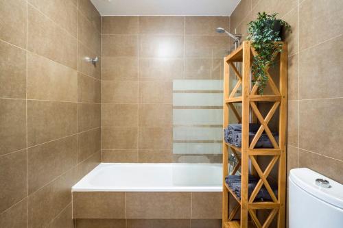 a bathroom with a bath tub and a toilet at Casa Corralito - 2 bedrooms, rooftop sea view in Cotillo